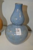 A Chinese pale blue glazed gourd shaped vase.