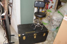 A typist's chair and a large trunk.
