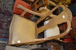 An oak high-back armchair.