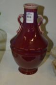 A Chinese flambe bottle vase with handles.