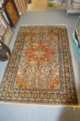 A Persian rug, beige ground with floral stylized decoration.