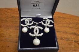 A decorative pendant with matching earrings.