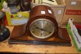 A mahogany mantle clock.