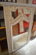 A white painted over mantle mirror.