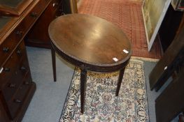 A mahogany oval coffee table.