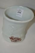 A small porcelain bamboo form brush pot.