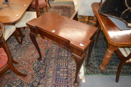 A George III mahogany foldover card table on cabriole legs.