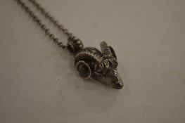 A ram's head pendant and chain.