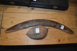 A boomerang and a carved nut.