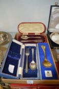A leather cased silver christening set and three other items.