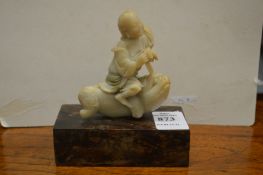 A 19th century Chinese carved soapstone small figure of a boy riding a beast.