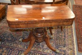 A 19th century mahogany D-shaped foldover card table on a fluted column support with four outswept
