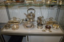 A pair of silver plated entree dishes and covers, a kettle on stand with burner, a good muffin