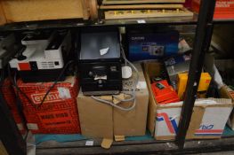 A boxed cine projector and other related camera equipment.