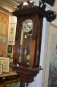 A walnut cased Vienna style regulator wall clock.