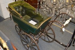 An unusual early Victorian pram with wooden wheels.