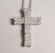 AN 18CT WHITE GOLD CROSS on a chain.