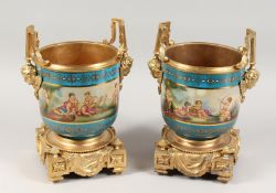 A PAIR OF PORCELAIN AND ORMOLU TWO-HANDLED JARDINIERES with blue ground and painted with a