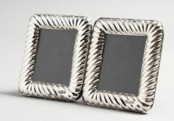 A PAIR OF ROPE EDGE SILVER PHOTOGRAPH FRAMES.