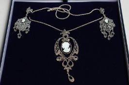 A SILVER MARCASITE CARVED MOTHER-OF-PEARL CAMEO NECKLACE AND EARRINGS.