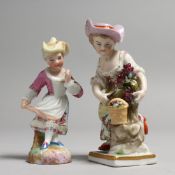 AN EARLY 19TH CENTURY CONTINENTAL FIGURE EMBLEMATIC OF AUTUMN, holding a scythe and grapes, and