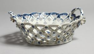 AN 18TH CENTURY PIERCED WORK BASKET with two handles, decorated with fir cones and an elaborate