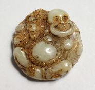 A CHINESE CARVED JADE ROUNDEL, BUDDHA. 1.75ins.