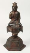 A BRONZE FIGURE OF BUDDHA on a pedestal, one open palm facing forward. 11ins high.