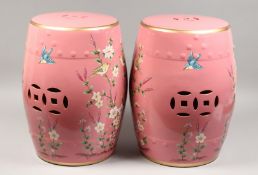 A PAIR OF PINK CHINESE PORCELAIN BARREL SEATS with flowers and birds. 17.5ins high.