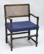A BEECH FRAMED BOBBIN TURNED ARMCHAIR, with cane work back and upholstered seat.