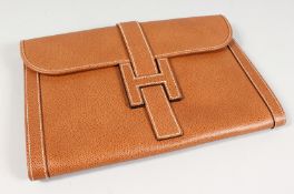 A BROWN LEATHER CLUTCH BAG. 11ins x 7.5ins.