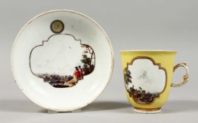 A GOOD 18TH CENTURY MEISSEN YELLOW GROUND CUP AND SAUCER with painted scenes of figures in a