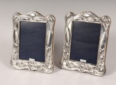A PAIR OF SILVER UPRIGHT PHOTOGRAPH FRAMES. Deco design. 7ins x 5.5ins.