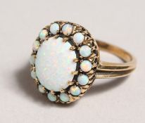 A 9CT GOLD OPAL CLUSTER RING.