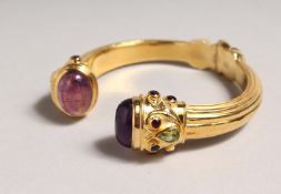 A CABOCHON SET AMETHYST AND PERIDOT BRACELET.