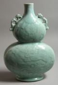 A CHINESE LIGHT BLUE DOUBLE GOURD VASE. Monogrammed in blue. 13ins high.