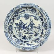 A LARGE CHINESE BLUE AND WHITE CHARGER with warriors. 19ins diameter.