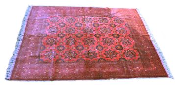 A GOOD PERSIAN CARPET, red ground with a design of large floral palmettes, within a similar