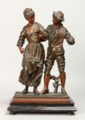 A 19TH CENTURY CONTINENTAL SPELTER GROUP OF A YOUNG LADY AND YOUNG MAN on a rectangular base.