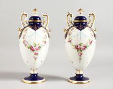 AN EARLY 20TH CENTURY MINTON PAIR OF TWO-HANDLED PEDESTAL, OVOID VASES painted by Dudley, signed,