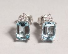 A GOOD PAIR OF 18CT WHITE GOLD, AQUAMARINE AND DIAMOND STUDS.