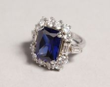 A SILVER AND FAUX TANZANITE RING.