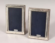 A PAIR OF SILVER UPRIGHT PHOTOGRAPH FRAMES. Bead Edge design. 6ins x 4ins.