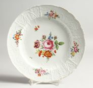 A 19TH CENTURY MEISSEN CIRCULAR PLATE with waved border and painted with flowers. Crossed swords