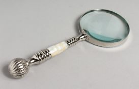 A NOVELTY MAGNIFYING GLASS with mother-of-pearl and chrome handle.