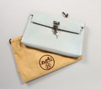 A HERMES PALE BLUE HANDBAG with lock and key in a dust bag and original box.