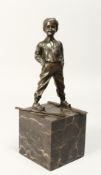 AFTER FERDINAND PRIESS (1882 - 1943) GERMAN A BRONZE FIGURE OF A YOUNG BOY ON SKIS, his hands in his