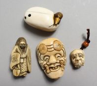 FOUR VARIOUS CARVED IVORY CHINESE NETSUKES, two masks, a figure and a duck.