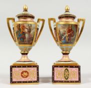 A GOOD SMALL PAIR OF BERLIN PORCELAIN TWO HANDLED URNS, COVERS AND STANDS painted with classical