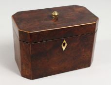 A GEORGE III AMBOYNA TEA CADDY, the hinged lid enclosing two compartments. 7ins wide.